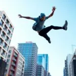 Athlete performing parkour in an urban environment.