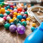 Colorful beads and tools for jewelry making on a table.