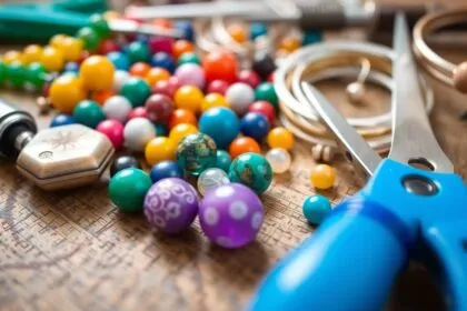 Colorful beads and tools for jewelry making on a table.