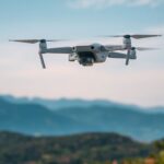 Drone flying over a picturesque landscape with mountains.