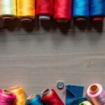 Colorful sewing materials on a wooden table.