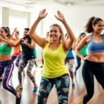 Diverse group dancing energetically in a Zumba class.