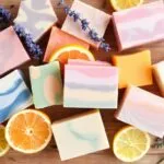 Colorful handmade soaps with natural ingredients on wood.