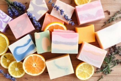 Colorful handmade soaps with natural ingredients on wood.