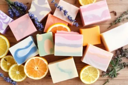 Colorful handmade soaps with natural ingredients on wood.