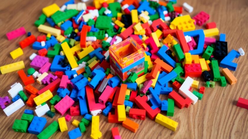 Colorful LEGO bricks on a wooden table with a structure.